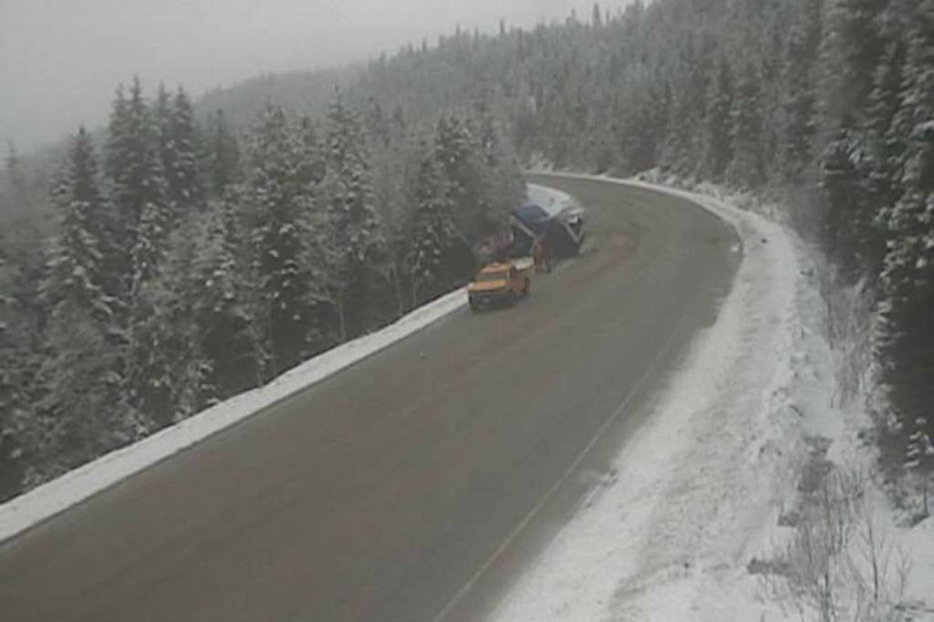 A photo on DriveBC from Feb. 27 at 9:01 a.m. shows a large vehicle in the bank off the road. It marks the location of the camera as Highway 5 about 20 km south of Blue River and 19 km north of Avola, looking north. (Drive BC)